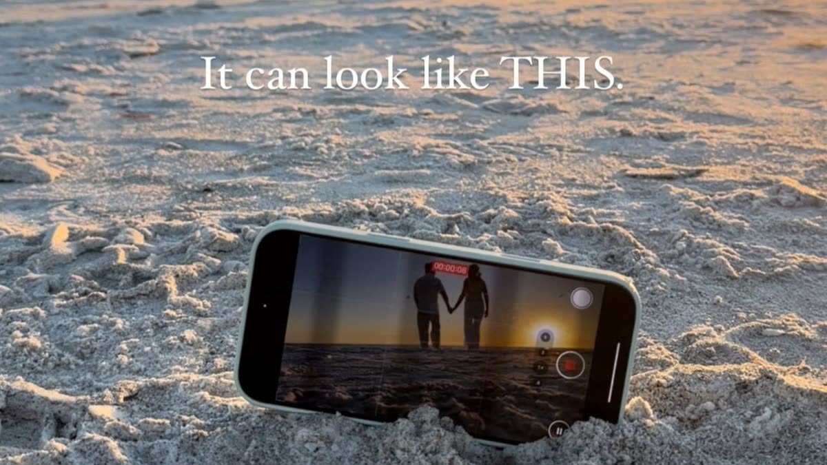 Alla and John of AJ Dream Travel on camera in a destination frame from one of their Instagram reels