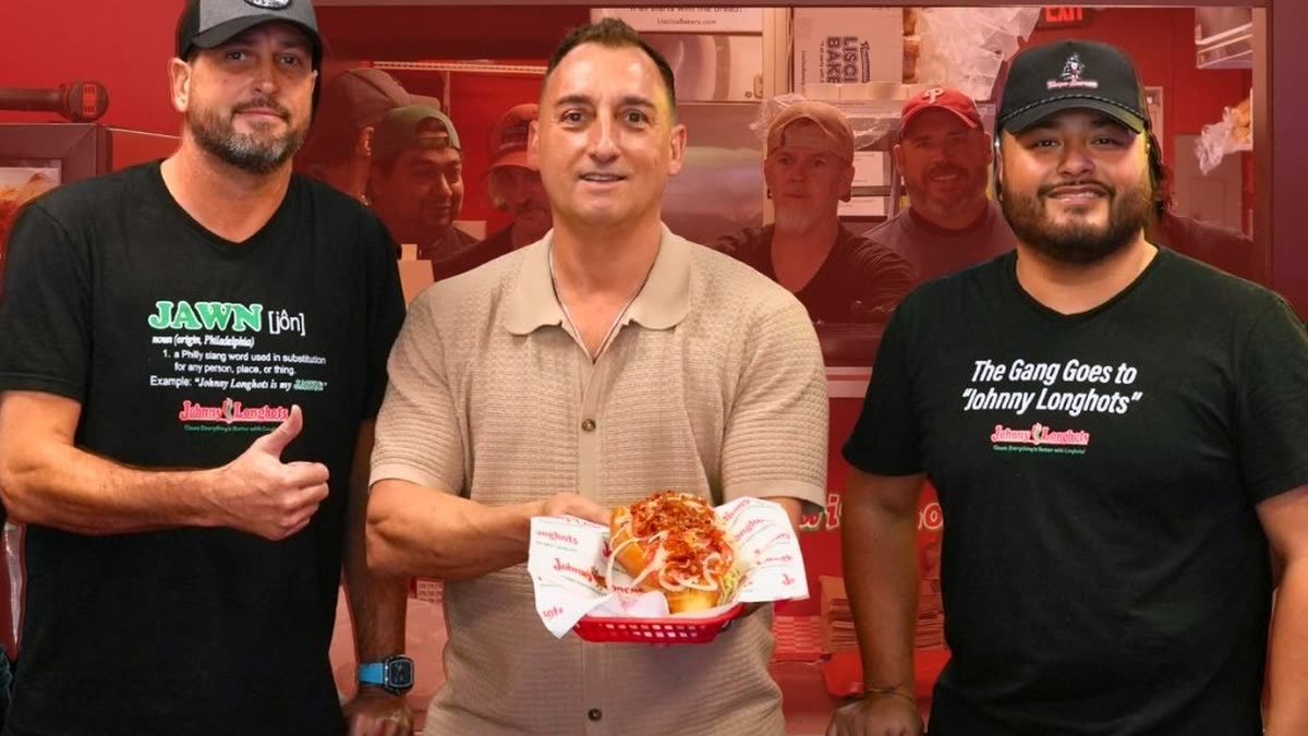 The team at Johnny Longhots Philly Steaks in Sarasota, one holding the cheesesteak from the YouTube Short